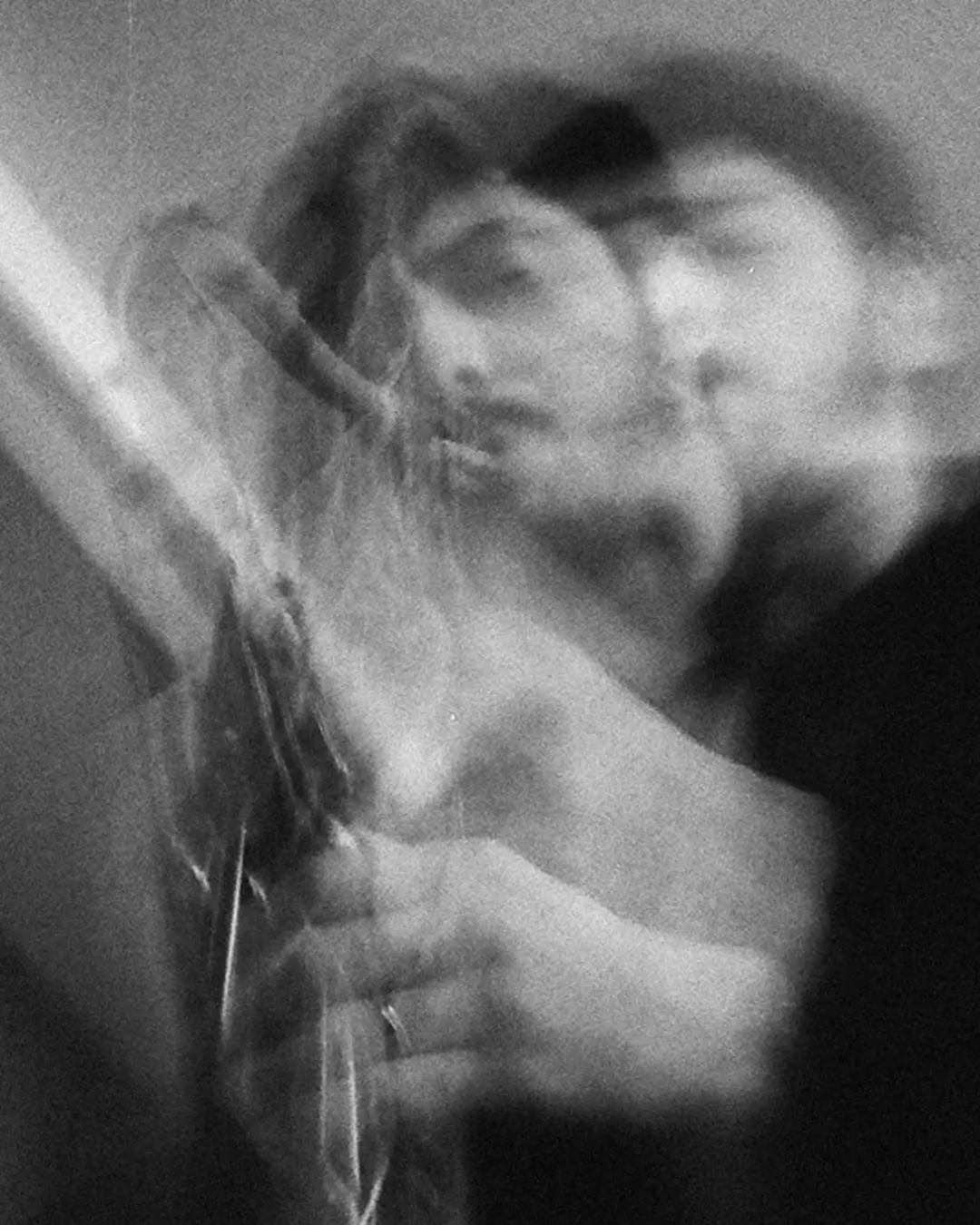 A saxophonist plays in an artistic black-and-white image with a blurred, double-exposure effect emphasizing movement and expression.