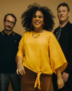 Zuco 103 bandfoto met zangeres Lilian Vieira en bandleden in warme gele setting